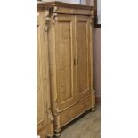 A 19th century French stripped pine two door wardrobe W.122cm