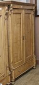 A 19th century French stripped pine two door wardrobe W.122cm