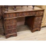 An Abbeycraft mahogany twin pedestal desk with leather top W.122cm