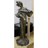 A spelter standing figure of a lady, wearing a flowing robe and holding a flower, H 70cm