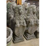 A set of four reconstituted stone lions bearing shields, W.25cm H.81cm