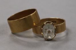 An 18ct gold wedding band and an 18ct gold paste-set ring, 10.5g gross.