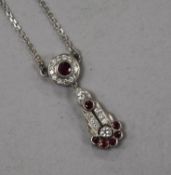 An 18ct white gold, ruby and diamond cluster drop pendant necklace, pendant 27mm.