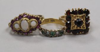 An early 20th century 22ct gold and gem set ring and two other gem set rings, 9ct & 18ct.