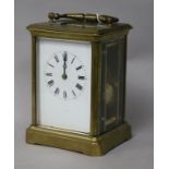 A French gilt brass carriage clock, having white enamelled Roman dial and striking on gong, H 13.