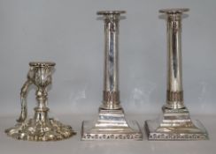 A pair of 19th century silver plated candlesticks and a rococco style chamberstick with swing