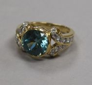 A modern 18ct gold, blue zircon and diamond set dress ring, size N.