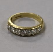 An 18ct gold and graduated seven stone diamond half hoop ring, total diamond weight is approximately