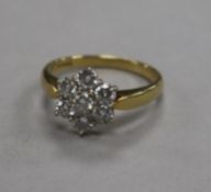 An 18ct gold and seven stone diamond cluster ring, size P.