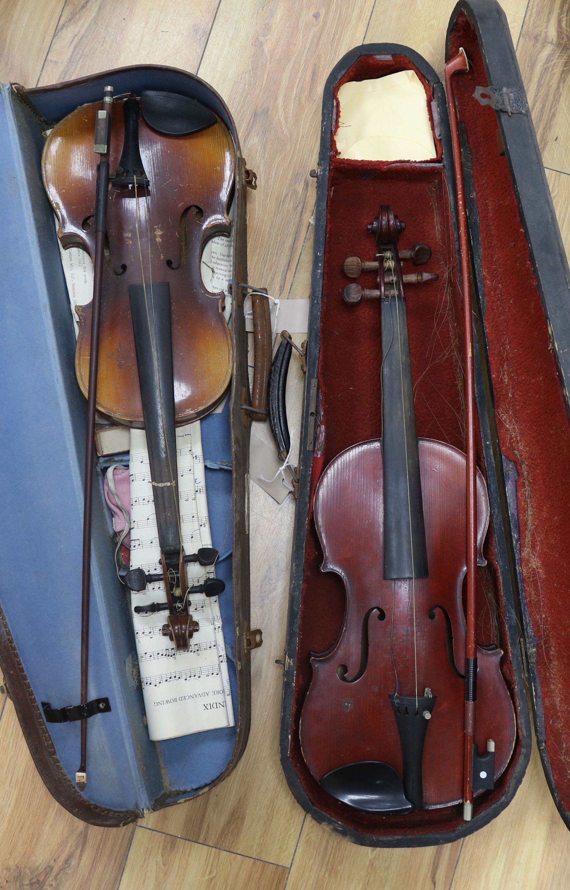 A full size violin, label Celebre Vosjen with case and a ¾ size violin bearing Strad label, case and