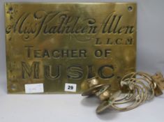 An Edwardian brass name plate and a pair of brass Art Nouveau piano sconces (3)