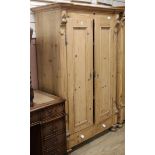 A 19th century French stripped pine two door wardrobe W.110cm