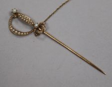 An early 20th century yellow metal and seed pearl set jabot pin modelled as a sword, 89mm.