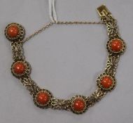 A 9ct gold and cabochon coral set pierced bracelet.