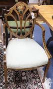 An Adam design satinwood painted and decorated shield back elbow chair