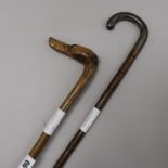 A carved wood Hound's head walking cane and a silver handled walking cane