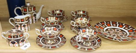 A Royal Crown Derby tea service, pattern no. 1128, comprising: teapot, sugar bowl and cover, milk