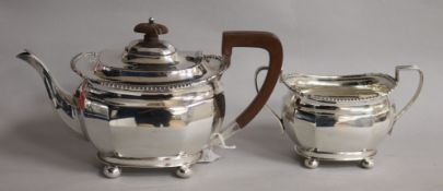 A silver two-piece tea service, comprising teapot and sucrier, of oval form, with gadroon rims and