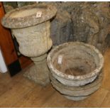A reconstituted stone campana-shaped urn and a pair of circular planters, H 66cm & Dia 43cm