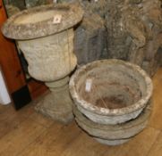 A reconstituted stone campana-shaped urn and a pair of circular planters, H 66cm & Dia 43cm