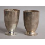 A stylish pair of George V ribbed silver beakers, on circular foot, Charles Boyton & Sons, London,