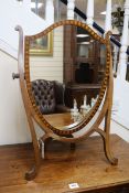 An Edwardian mahogany shield-shaped toilet mirror W.55cm.