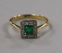 A 1930's/1940's 18ct gold, emerald and diamond cluster tablet ring, size M.