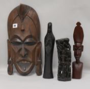 A carved tribal mask and three carvings mask height 40cm