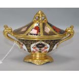 A Royal Crown Derby two-handled oval pedestal urn and cover, pattern no. 1128 width 19cm height