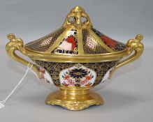 A Royal Crown Derby two-handled oval pedestal urn and cover, pattern no. 1128 width 19cm height