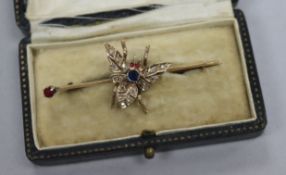 An early 20th century yellow metal, ruby, sapphire and diamond set bug brooch, 53mm.