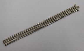 A 9ct gold and diamond set multi line bracelet with forty rows of five small diamonds, total carat