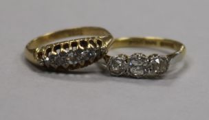 Two diamond set rings, including an 18ct gold and platinum three stone ring.