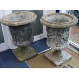 A pair of reconstituted stone campana-shaped urns with classical figures in relief, H 85cm W.63cm