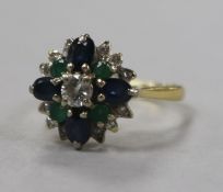A 1970's 18ct gold, emerald, sapphire and diamond cluster ring, size M.