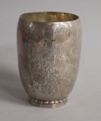 A 1920's Georg Jensen Danish planished sterling silver beaker, date for 1924, on decagonal foot,