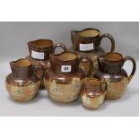 Six graduated Doulton jugs