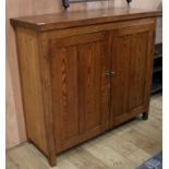 A pitch pine two door cupboard W.128cm