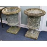 A pair of reconstituted stone campana-shaped urns with classical figures in relief, H 85cm W.63cm