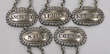A set of five silver sauce labels by Reily & Storer; Anchovy, Cayenne, Ketchup, Lemon & Soy,