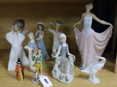 A group of Lladro figures and an extinguisher