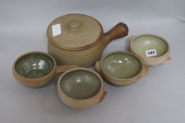 A quantity of St Ives Pottery including a casserole pot and four celadon glazed bowls