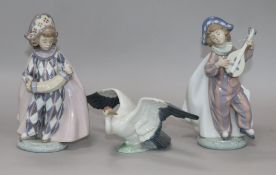 Two Lladro figures of harlequins and another of a crane