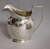 An Edwardian silver helmet shaped cream jug, Nathan & Hayes, Chester, 1907, 5 oz.