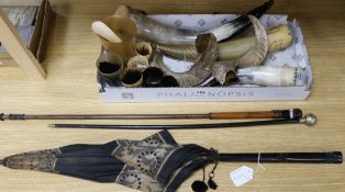 A collection of powder horns, horn beakers and a silver vesta case, two sticks and a parasol