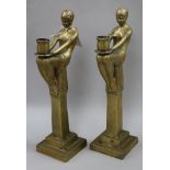 A pair of figural brass candlesticks height 42cm