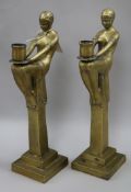 A pair of figural brass candlesticks height 42cm