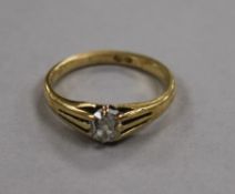 An 18ct gold and claw set solitaire diamond ring, size P.