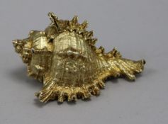 A silver gilt shell paperweight