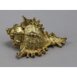 A silver gilt shell paperweight